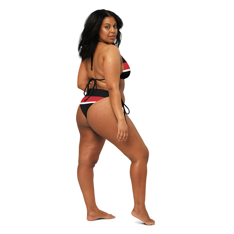 Side view of a model wearing a Tricolored Blackbird recycled string bikini