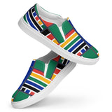 An abstract view featuring the Rainbow Nation Women’s slip-on canvas shoes with their toes down and heels up suspending in midair