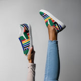A fun view of someone holding up a pair of Rainbow Nation Women’s slip-on canvas shoes