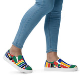 A side view of someone walking in a pair of Rainbow Nation Women’s slip-on canvas shoes